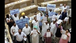 AAP and BJP councillors protesting against each other during the House meeting at the MC office in Sector 17, Chandigarh, on Tuesday. (Keshav Singh/HT)