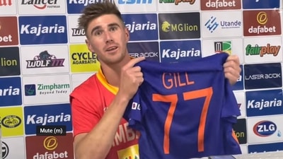Zimbabwe's Brad Evans shows Shubman Gill's jersey in press conference