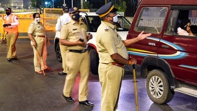 (File photo/ representational) Police officers stop commuters at Girgaum Chowpatty during night curfew in Mumbai. (PTI) (File photo/ representational) Police officers stop commuters at Girgaum Chowpatty during night curfew in Mumbai. (PTI)