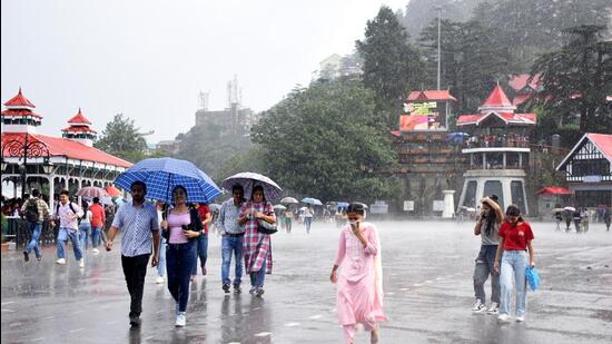 Visitors out in the rain at the Ridge, in Shimla, Himachal Pradesh, India, on Sunday, August 21, 2022. (Photo by Deepak Sansta / Hindustan Times) (HT Photo)