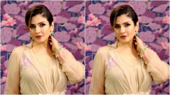 Raveena decked up in an ivory white kurta with collars and full sleeves, and minimal floral embroidery in the shades of white and pink. The kurta also featured an embellished belt detail at the waist.(Instagram/@officialraveenatandon)