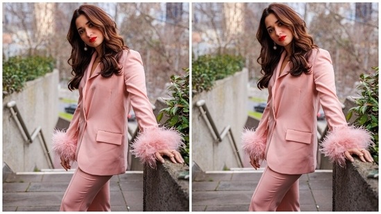 Tamannaah teamed the blazer with matching blush-pink pants that could easily be a part of your summer staples. It features feather trim detailing on the hemline, contrast satin waistband, fitted silhouette, and pocket detailing on the back.(Instagram)