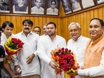 Bihar chief minister Nitish Kumar and deputy CM Tejashwi Yadav greet acting speaker Maheshwar Hazari during the special session of Assembly on Wednesday.(PTI) Bihar chief minister Nitish Kumar and deputy CM Tejashwi Yadav greet acting speaker Maheshwar Hazari during the special session of Assembly on Wednesday.(PTI)