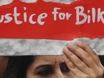 A woman holds a placard during a protest against the release of men convicted of gang-raping Bilkis Bano during the 2002 communal riots in Gujarat.(AFP) A woman holds a placard during a protest against the release of men convicted of gang-raping Bilkis Bano during the 2002 communal riots in Gujarat.(AFP)