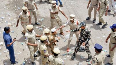 Police attempt to detain a protestor during a demonstration against T Raja Singh. (PTI) Police attempt to detain a protestor during a demonstration against T Raja Singh. (PTI)