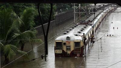 Mumbai Monsoon Floods - Train gets submerged near a Station due to heavy rains on Tuesday, at Chunabhatti on Wednesday. (12.00pm). Thousands of people were stranded in their offices, railway stations, trains, buses and even schools following incessant rains. HT Photo by Vijayanand Gupta. 27/07/05
