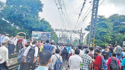 Passengers protest against Railways' decision to change the 8:20 am non-AC Thane-CSMT train into an AC local service at Kalwa car shed on Friday. (Praful Gangurde/HT Photo) Passengers protest against Railways' decision to change the 8:20 am non-AC Thane-CSMT train into an AC local service at Kalwa car shed on Friday. (Praful Gangurde/HT Photo)