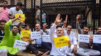 Supporters of RJD protest against the raids. (PTI) Supporters of RJD protest against the raids. (PTI)