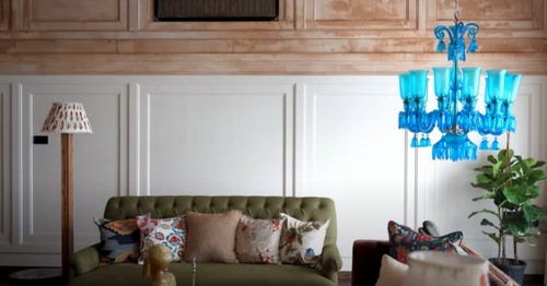 The living room at Aparshakti Khurana and wife Aakriti Ahuja's Mumbai home features a statement-making blue chandelier.