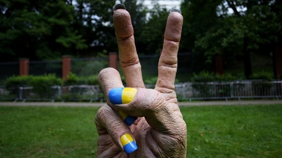 A statue of a hand with finger nails painted in Ukraine's national colors was placed in front of the Russian embassy in Prague, Czech Republic.(AP)