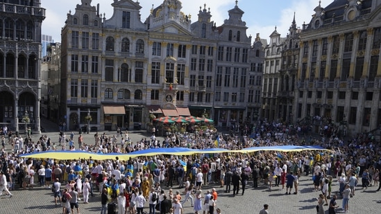 A giant Ukrainian flag is unfurled during an event for Ukrainian Independence Day in the historical Grand Place of Brussels.(AP)