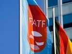 A flag with the logo of the Financial Action Task Force, FATF, waves in the wind next to the German national falg during a meeting of the task force at the Congress Center in Berlin, Germany.(AP) A flag with the logo of the Financial Action Task Force, FATF, waves in the wind next to the German national falg during a meeting of the task force at the Congress Center in Berlin, Germany.(AP)