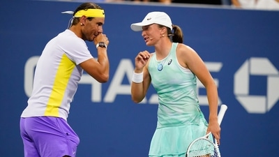 Rafael Nadal, of Spain, left, speaks to Iga Swiatek, of Poland, during "The Tennis Plays for Peace" exhibition match (AP) Rafael Nadal, of Spain, left, speaks to Iga Swiatek, of Poland, during "The Tennis Plays for Peace" exhibition match (AP)
