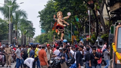 Devotees walk alongside an idol of elephant-headed Hindu deity Ganesha through a street, ahead of the Ganesh Chaturthi festival in Mumbai. (AFP) Devotees walk alongside an idol of elephant-headed Hindu deity Ganesha through a street, ahead of the Ganesh Chaturthi festival in Mumbai. (AFP)