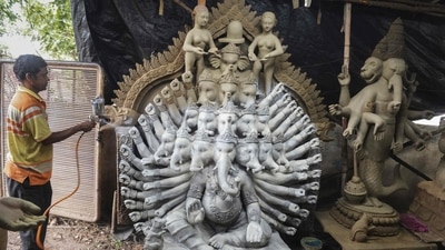 An artisan sprays paint on eco-friendly idols of the Hindu god lord Ganesha made with mud, jute and bamboo to reduce water pollution during the immersion rituals ahead of the Ganesh Chaturthi festival, at a workshop on the outskirts of Hyderabad. (AFP) An artisan sprays paint on eco-friendly idols of the Hindu god lord Ganesha made with mud, jute and bamboo to reduce water pollution during the immersion rituals ahead of the Ganesh Chaturthi festival, at a workshop on the outskirts of Hyderabad. (AFP)