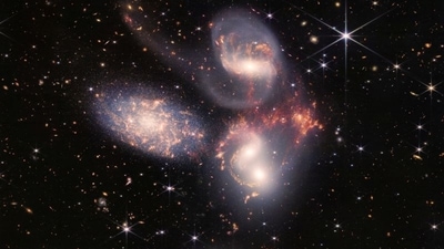 A group of five galaxies that appear close to each other in the sky: two in the middle, one toward the top, one to the upper left, and one toward the bottom are seen in a mosaic or composite of near and mid-infrared data from NASA's James Webb Space Telescope.&nbsp; (Reuters)