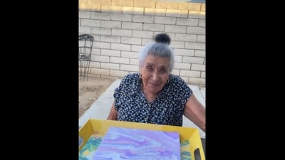The image, taken from the viral video on Instagram, shows an elderly woman painting a canvas. (Instagram/@abuelitas_paintings)