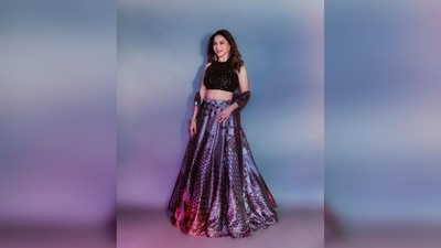 Madhuri Dixit's outfit comprises a black dazzling halter neck blouse, printed skirt and a stole. (Instagram/@madhuridixitnene)