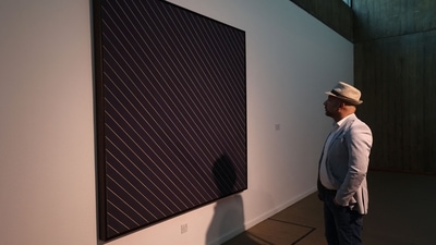 A visitor looks at an installation by American painter Frank Stella, during the "Minimalism and Conceptual Art" exhibition in Tehran. (AFP)