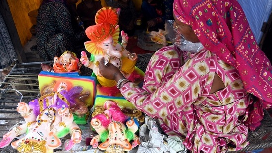 An artist gives final touch to idols of Lord Ganesh at a workshop ahead of the Ganesh Chaturthi festival in Delhi.(ANI)