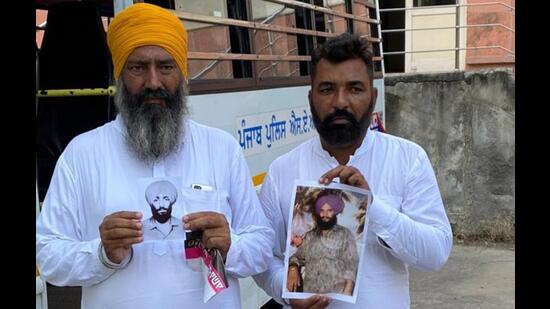 Shamsher Singh (yellow patka) nephew of victim Balwinder Singh and Sartaj Singh brother of another victim Sahib Singh showing their photographs. Shamsher Singh (yellow patka) nephew of victim Balwinder Singh and Sartaj Singh brother of another victim Sahib Singh showing their photographs.