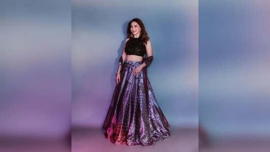 Madhuri Dixit's outfit consisted of a black shiny halter blouse, printed skirt and a stole.  (Instagram/@madhuridixitnene)