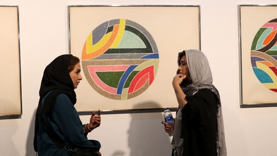 Visitors look at Sinjerli Variations I-V, by American painter Frank Stella made in 1977.(AFP)