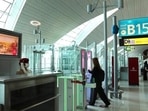 A woman enters the face and iris-recognition gate to board a plane, during a media tour at Dubai Airport, in the UAE. A woman enters the face and iris-recognition gate to board a plane, during a media tour at Dubai Airport, in the UAE.