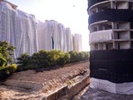 Buildings of a society near Supertech's 40-storey twin towers being covered ahead of the towers' scheduled demolition on August 28.(PTI) Buildings of a society near Supertech's 40-storey twin towers being covered ahead of the towers' scheduled demolition on August 28.(PTI)