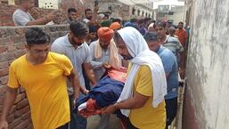 Residents of Balana village, 20km from Ambala town, taking the body of one of the victims for post-mortem on Friday morning. Six members of a family were found dead under mysterious circumstances. (HT Photo)