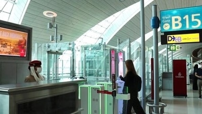 A woman enters the face and iris-recognition gate to board a plane, during a media tour at Dubai Airport, in the UAE. (AP / File) A woman enters the face and iris-recognition gate to board a plane, during a media tour at Dubai Airport, in the UAE. (AP / File)