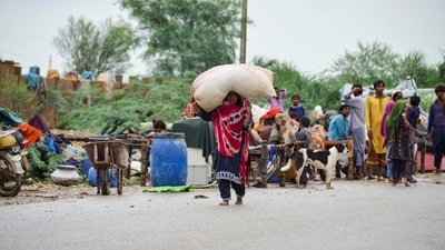 Flood victims take refuge on higher grounds following rains and floods in the country, (REUTERS)