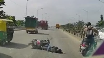 The horrific clip - that was apparently recorded in a dash camera of a car behind the bike - showed a woman hitting the ground.&nbsp; (Screen grab from Twitter video)