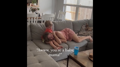 The image, taken from the viral Instagram video, shows a mother laying on her child's lap.&nbsp; (Instagram/@thesefourflowers)