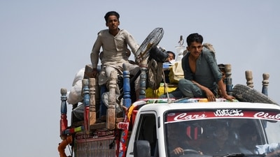 A family with their belongings travels on a vehicle to a higher ground following rains and floods during the monsoon season in Jamshoro, Pakistan. (REUTERS)