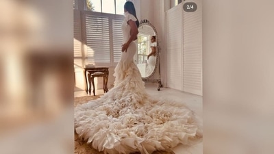 More than 1,000 hand-cut handkerchiefs and 1,640 feet of fabric were cut into ruffles and attached by hand, creating a voluminous, romantic skirt. Each handkerchief becomes a nostalgic keepsake and a modern heirloom, while the intricate constructed ruffled sleeves become a statement in craftsmanship and dignified design. (Courtesy of OntheJLo.com) More than 1,000 hand-cut handkerchiefs and 1,640 feet of fabric were cut into ruffles and attached by hand, creating a voluminous, romantic skirt. Each handkerchief becomes a nostalgic keepsake and a modern heirloom, while the intricate constructed ruffled sleeves become a statement in craftsmanship and dignified design. (Courtesy of OntheJLo.com)