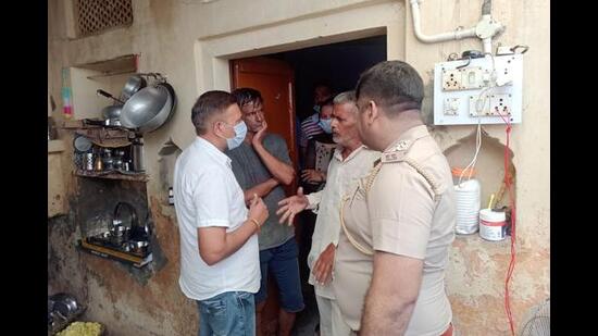 Police questioning a neighbor of the family at Balana village in Ambala district on Friday.  (HT Photo)