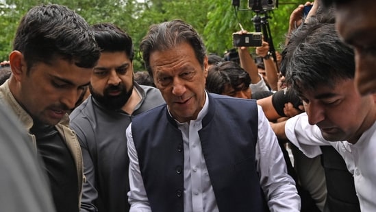 TOPSHOT - Former Pakistani prime minister Imran Khan (C) arrives to appear before the an anti-terrorist court in Islamabad.&nbsp;(AFP)