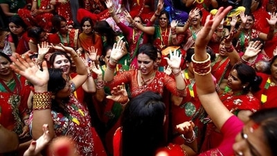 Hartalika Teej is predominantly celebrated in Nepal, Northern and Western India to welcome the monsoon season. Nepali Hindu women observe the festival by getting into their best traditional outfits (preferably red), fasting, singing folk songs, dancing and worshipping Lord Shiva and Goddess Parvati. This year Hartalika Teej will be falling on 30th August 2022. Here is how Nepalese women observe this festival. (Reuters) Hartalika Teej is predominantly celebrated in Nepal, Northern and Western India to welcome the monsoon season. Nepali Hindu women observe the festival by getting into their best traditional outfits (preferably red), fasting, singing folk songs, dancing and worshipping Lord Shiva and Goddess Parvati. This year Hartalika Teej will be falling on 30th August 2022. Here is how Nepalese women observe this festival. (Reuters)