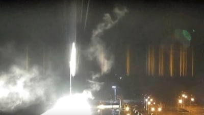 This image made from a video released by Zaporizhzhia nuclear power plant shows bright flaring objects landing in grounds of the nuclear plant in Enerhodar, Ukraine. (AP)
