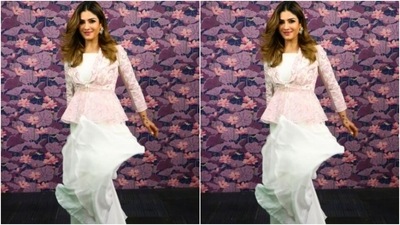 Raveena decked up in a cropped white tube top and teamed it with a pair of white silk sharara set with wide legs. She added more pop of colours to her look with a full-sleeved white jacket that came intricately embroidered in pink resham threads and silver mirror work. (Instagram/@officialraveenatandon)
