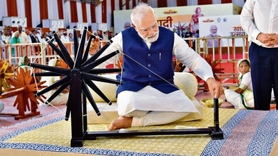 PM Narendra Modi spinning ‘Charkha’ in Khadi Utsav at the Sabarmati River Front, in Ahmedabad on Saturday. (ANI) PM Narendra Modi spinning ‘Charkha’ in Khadi Utsav at the Sabarmati River Front, in Ahmedabad on Saturday. (ANI)