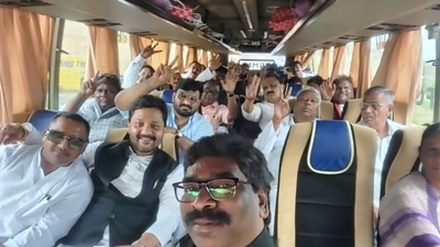 In pictures tweeted by news agency ANI, the legislators of the ruling JMM-Congress-RJD coalition were seen seated in a bus, all smiles, as they flashed victory signs to the camera. (ANI) In pictures tweeted by news agency ANI, the legislators of the ruling JMM-Congress-RJD coalition were seen seated in a bus, all smiles, as they flashed victory signs to the camera. (ANI)