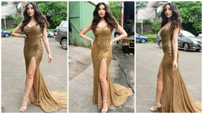 Nora Fatehi earlier wore a golden thigh-high slit body-grasping golden dazzling floor-sweeping gown teamed to the sets of Jhalak Dikhhla Jaa. (HT Photo/Varinder Chawla) Nora Fatehi earlier wore a golden thigh-high slit body-grasping golden dazzling floor-sweeping gown teamed to the sets of Jhalak Dikhhla Jaa. (HT Photo/Varinder Chawla)