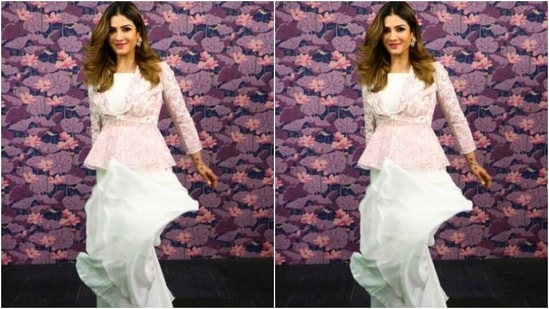 Raveena decked up in a cropped white tube top and teamed it with a pair of white silk sharara set with wide legs. She added more pop of colours to her look with a full-sleeved white jacket that came intricately embroidered in pink resham threads and silver mirror work.(Instagram/@officialraveenatandon)
