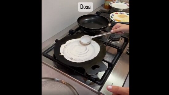 The image, taken from the Instagram video, shows an India woman teaching her Dutch daughter-in-law how to cook dosa.(Instagram/@prabhuvisha)