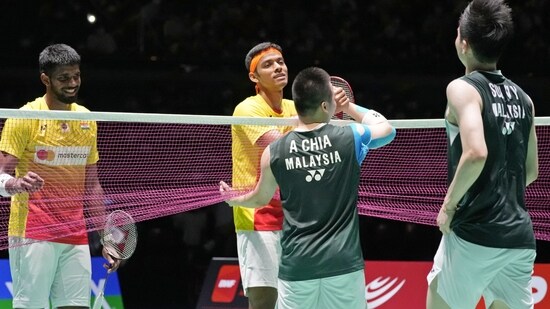 Malaysia's Aaron Chia, center, and Soh Wooi Yik, right, are congratulated by Satwiksairaj Rankireddy, left, and Chirag Shetty, center, of India after their men's doubles semifinal in the BWF World Championships in Tokyo.(AP)