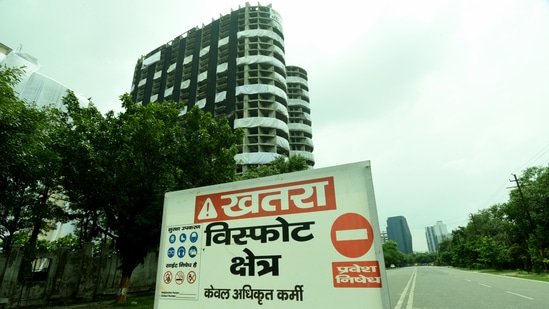 A Caution board installed in front of the Supertech twin towers ahead of its demolition at Noida’s Sector 93A.&nbsp;(Sunil Ghosh/HT )