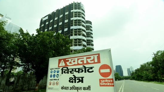 A Caution board installed in front of the Supertech Twin towers ahead of its demolition at Noida’s Sector 93A. (Sunil Ghosh / Hindustan Times)