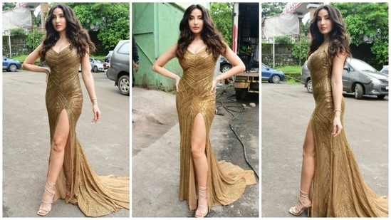 Nora Fatehi earlier wore a golden thigh-high slit body-grasping golden dazzling floor-sweeping gown teamed to the sets of Jhalak Dikhhla Jaa.&nbsp;(HT Photo/Varinder Chawla)
